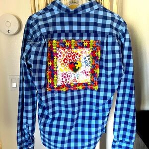 Women’s button-down shirt with puzzle piece/heart patch on back